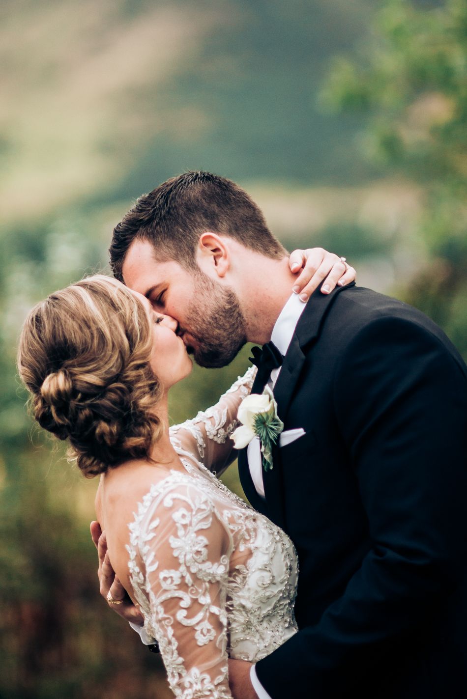 Intimate wedding portrait outdoors with delicate lace details and natural lighting.
