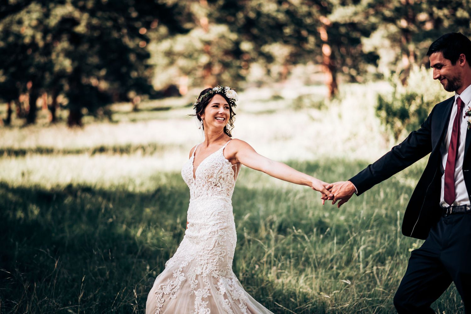 Elegant wedding celebration with dancing couple in outdoor mountain setting.