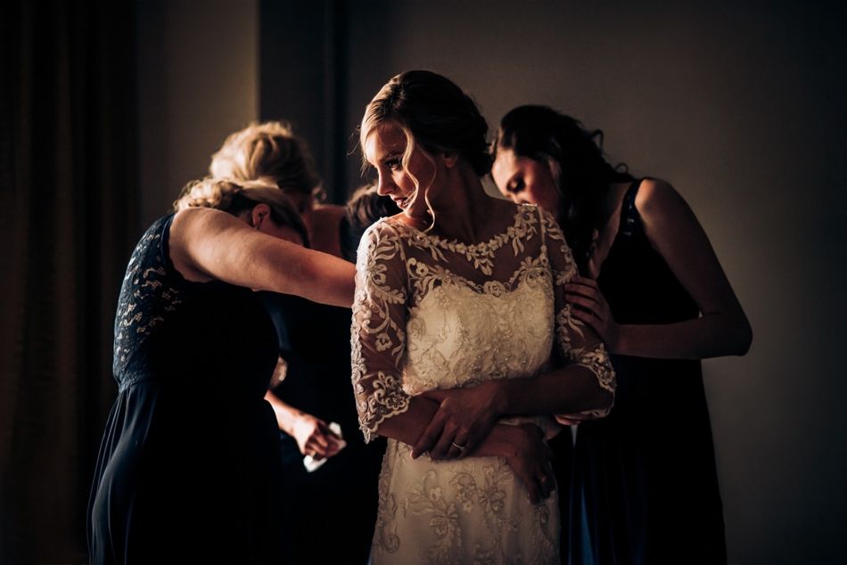 Final dress preparations being made in dramatic low-light setting.