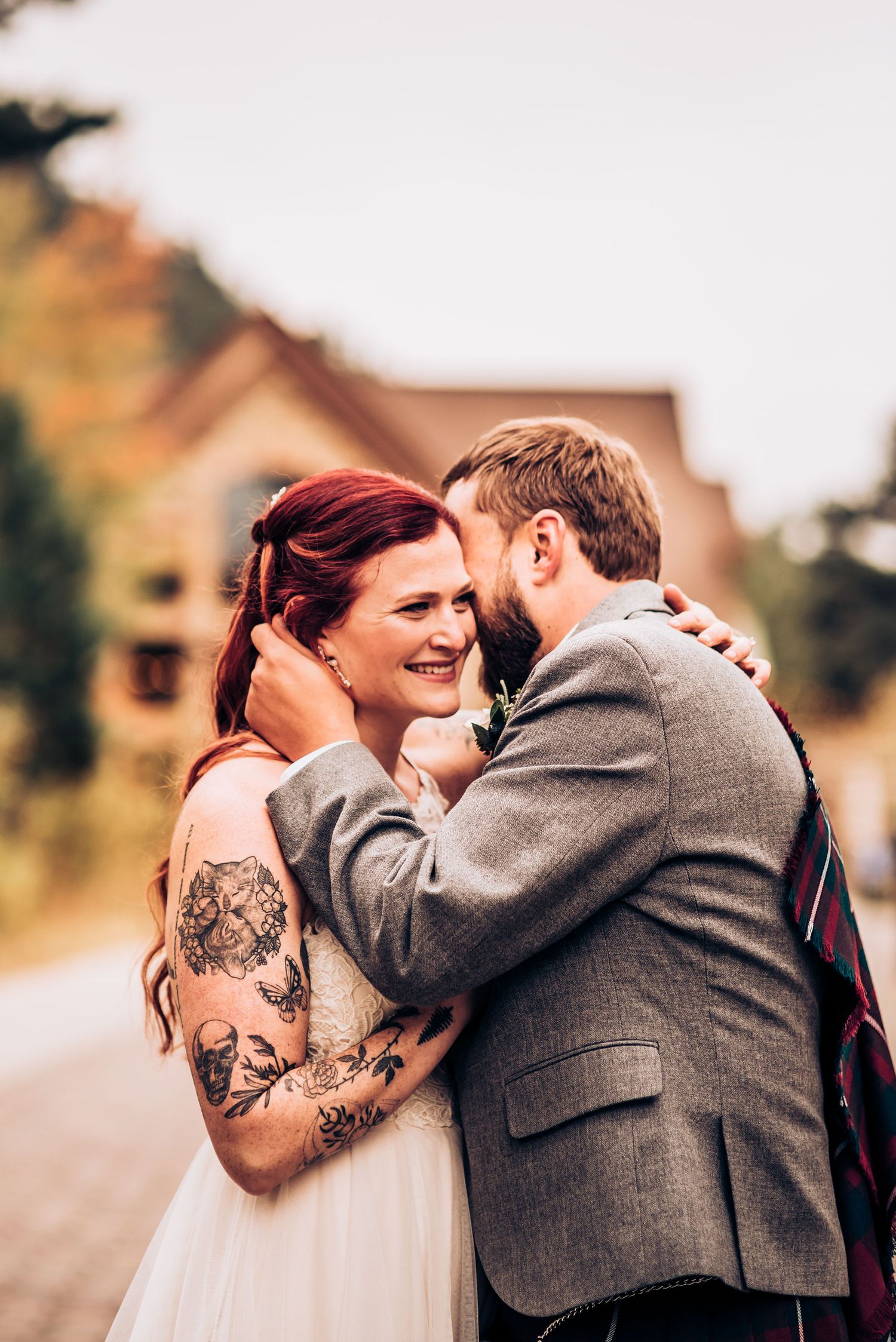 A romantic moment between newlyweds on a mountain path.
