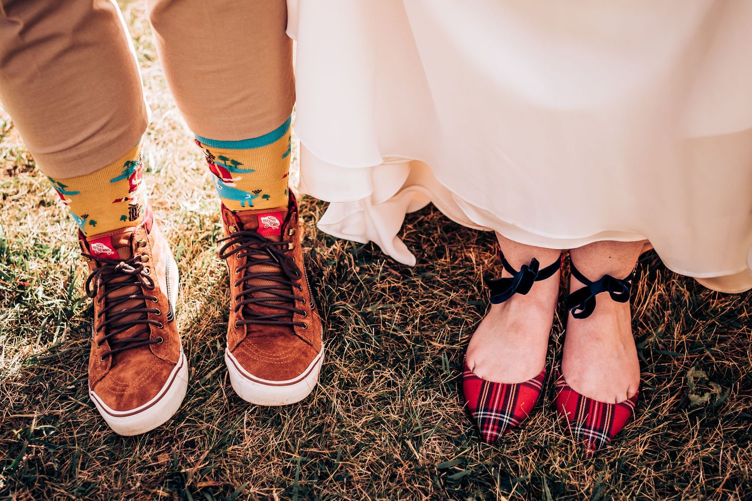 Fun sock and shoe detail shot showing colorful socks and casual footwear against white dress and khakis.