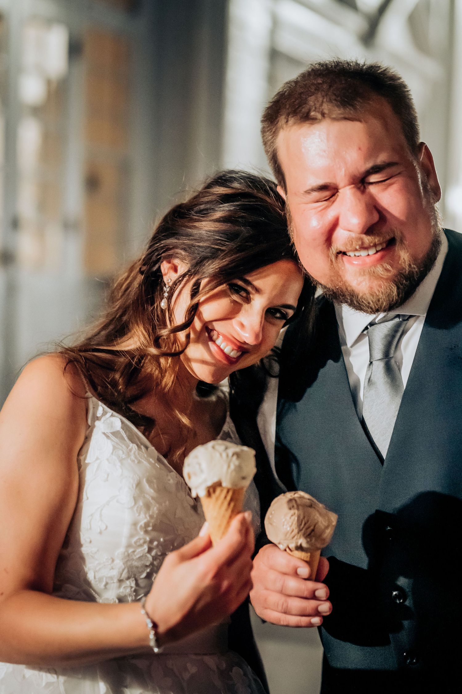 Newlyweds enjoy ice cream cones together at their wedding celebration.