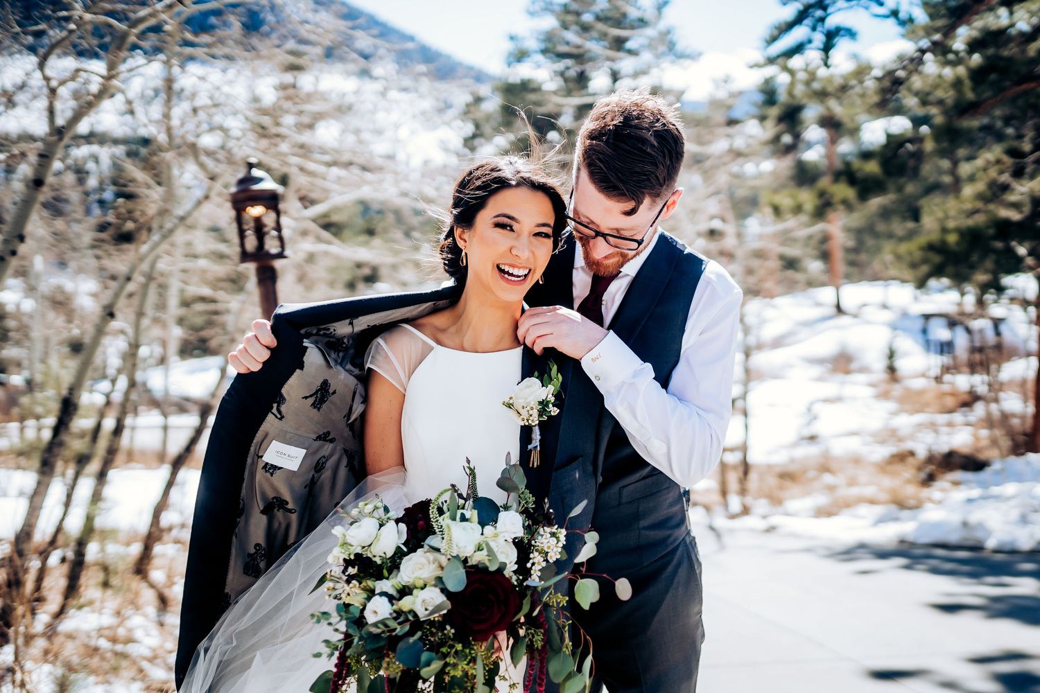 Winter wedding scene with elegant bouquet and snowy mountain backdrop.