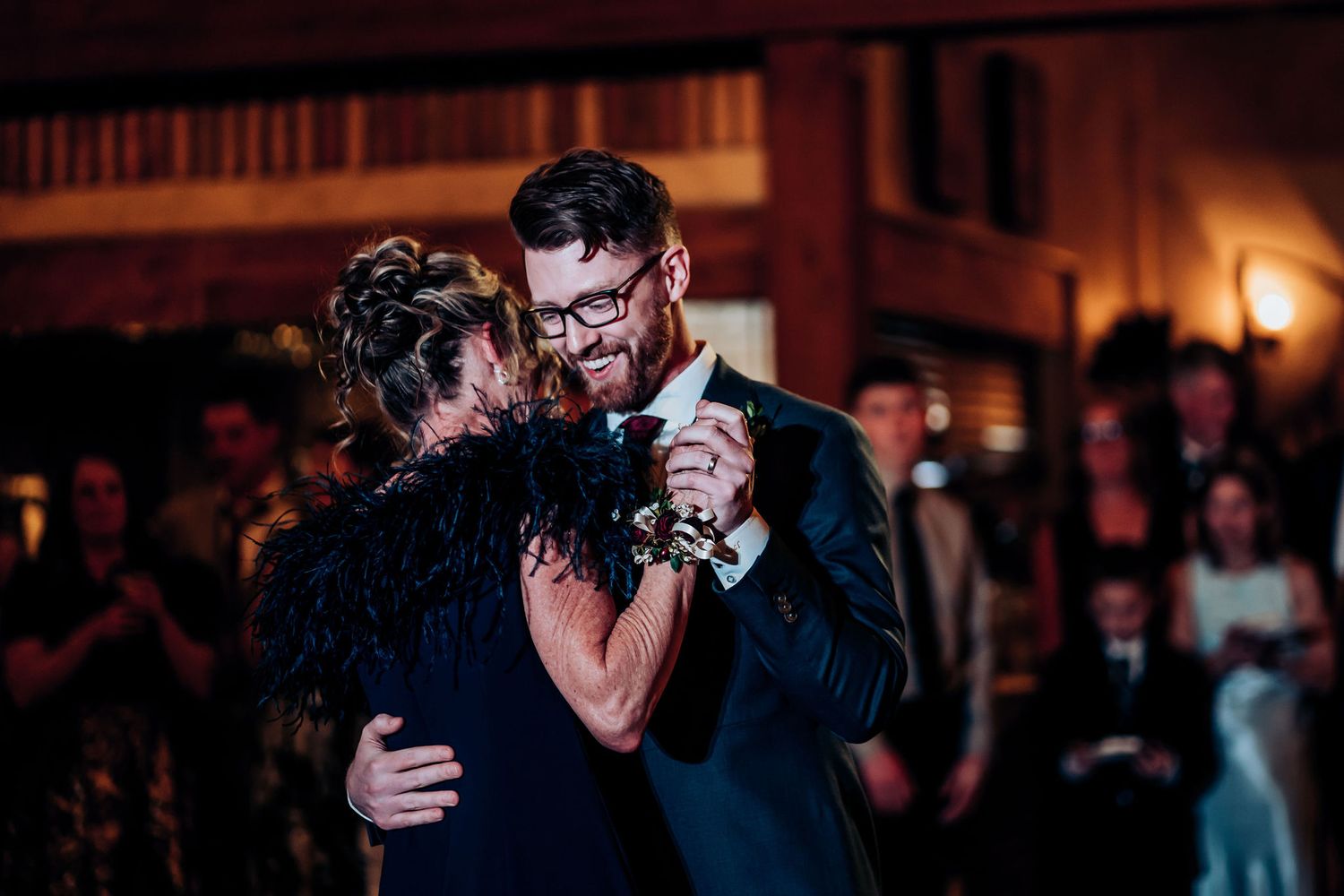 Dancers move gracefully across a rustic ballroom floor during an elegant evening celebration.