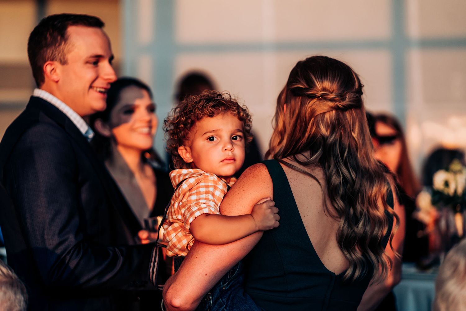 Wedding reception gathering with guests and formal attire.