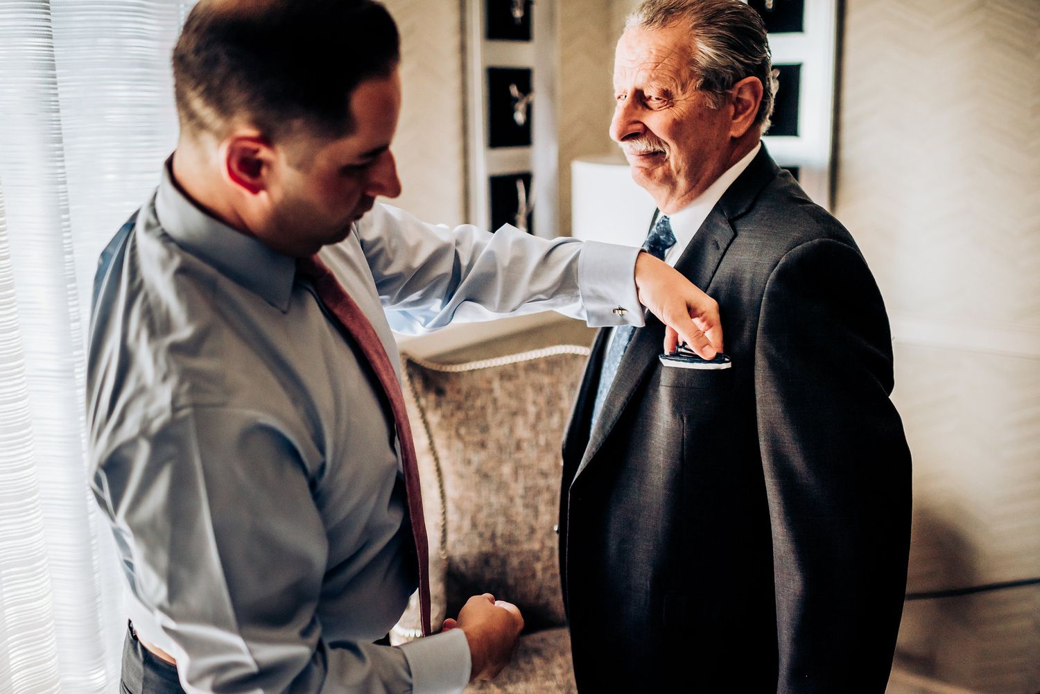 Two people in formal attire engaged in conversation during an event.