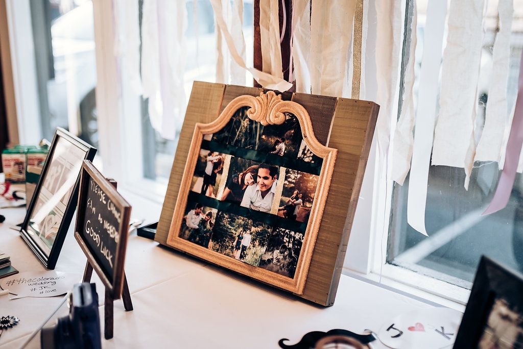 A vintage-style wooden clipboard displaying photo collages hangs near a window with soft natural lighting.