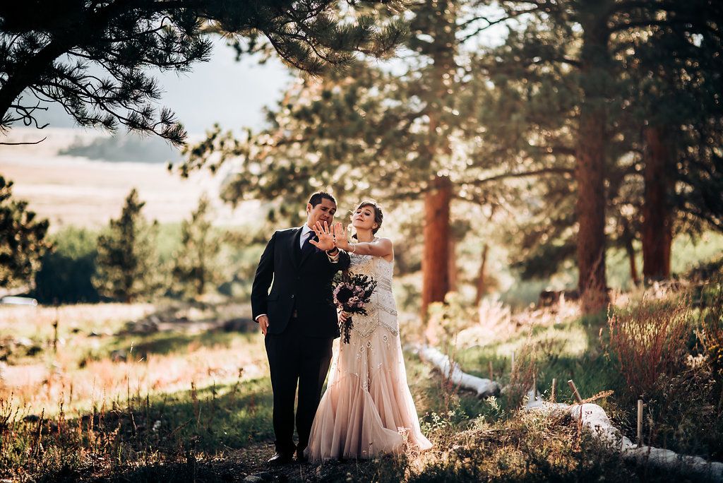 Sunset mountain wedding portrait with pine trees and golden light.