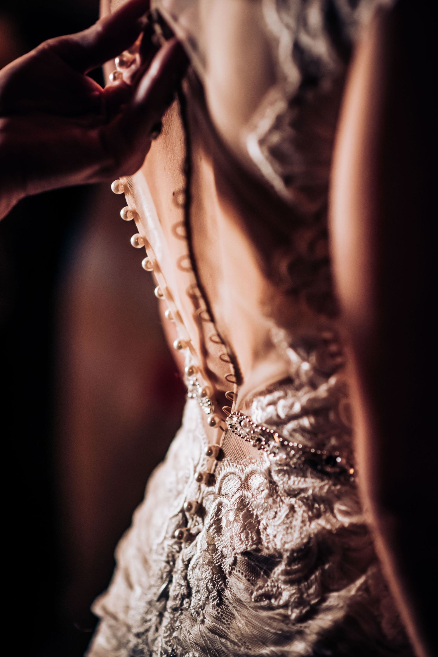 Close-up detail of intricate beadwork on a wedding dress back.