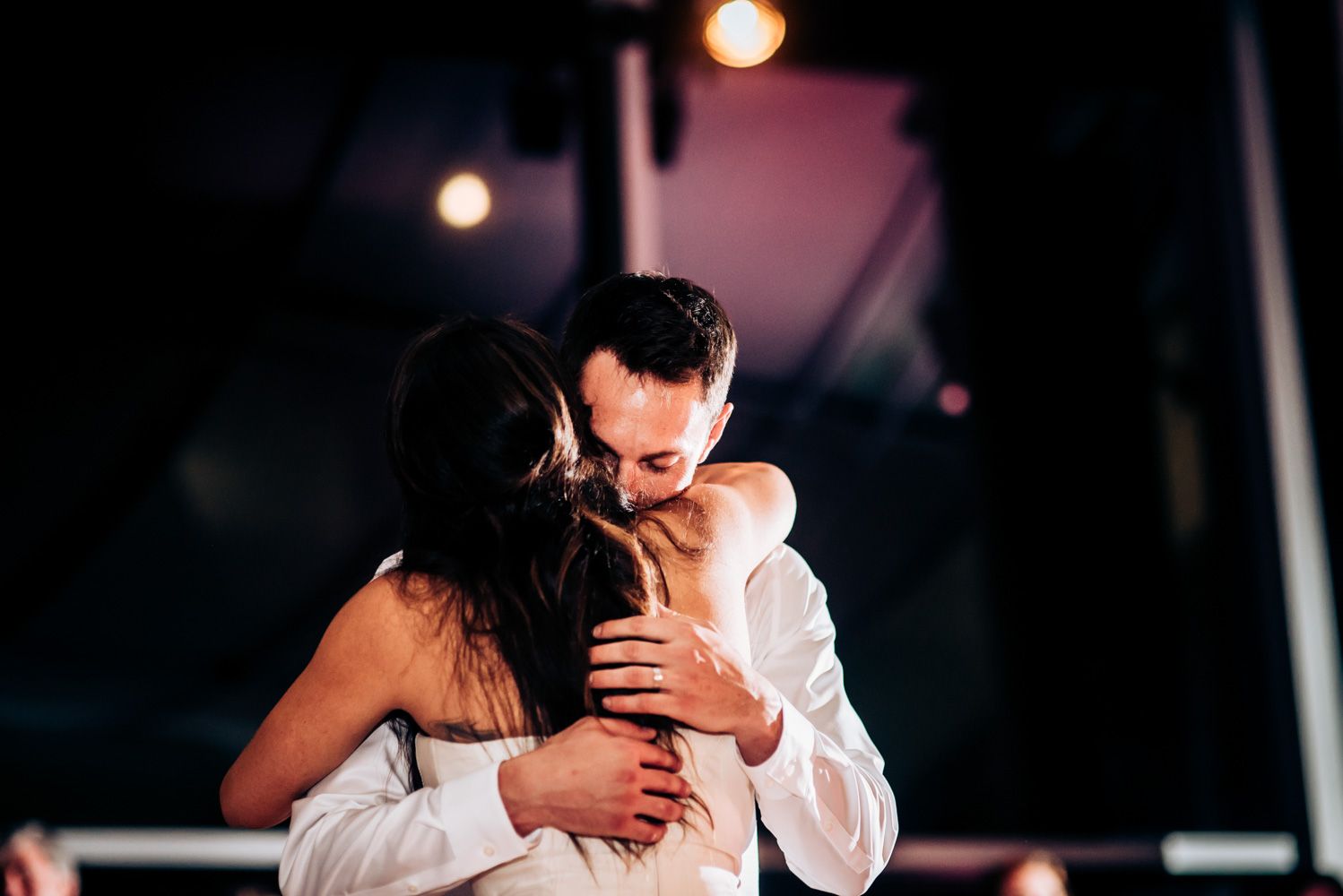 A romantic slow dance moment captured between newlyweds at their reception.