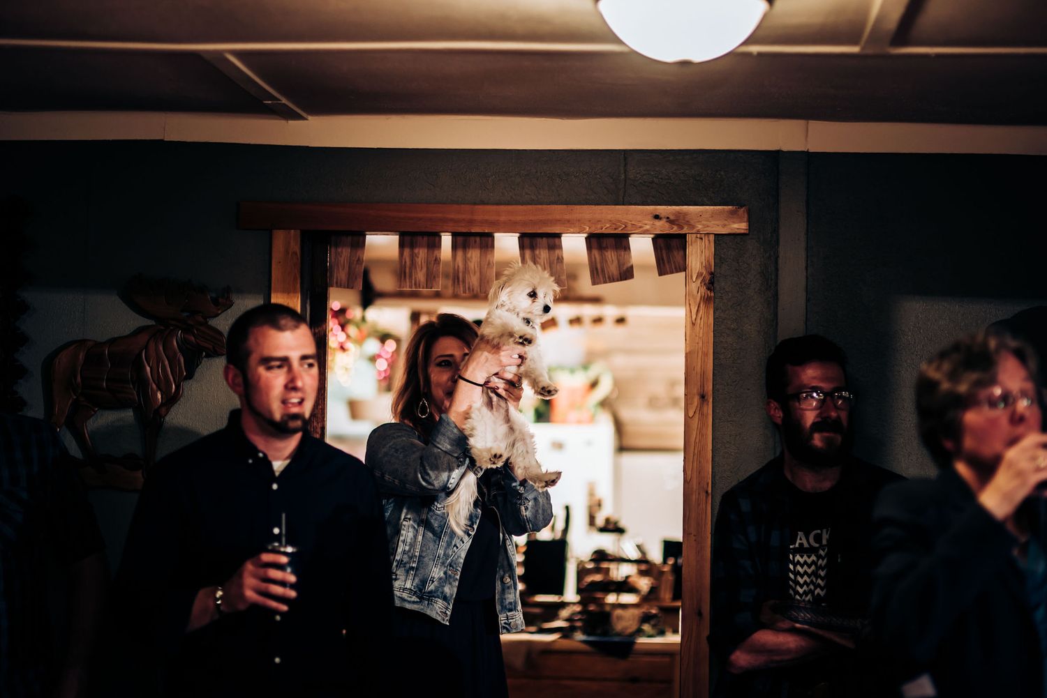 People enjoying drinks in a dimly lit room with ambient lighting.