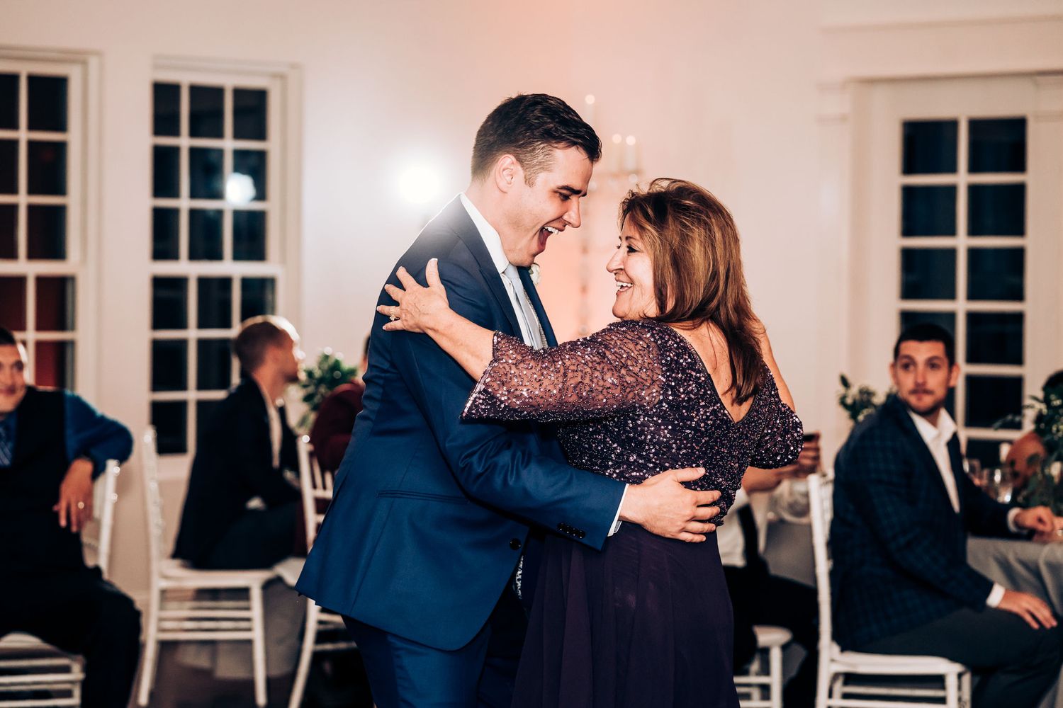 Guests share a warm embrace during the wedding reception celebration.