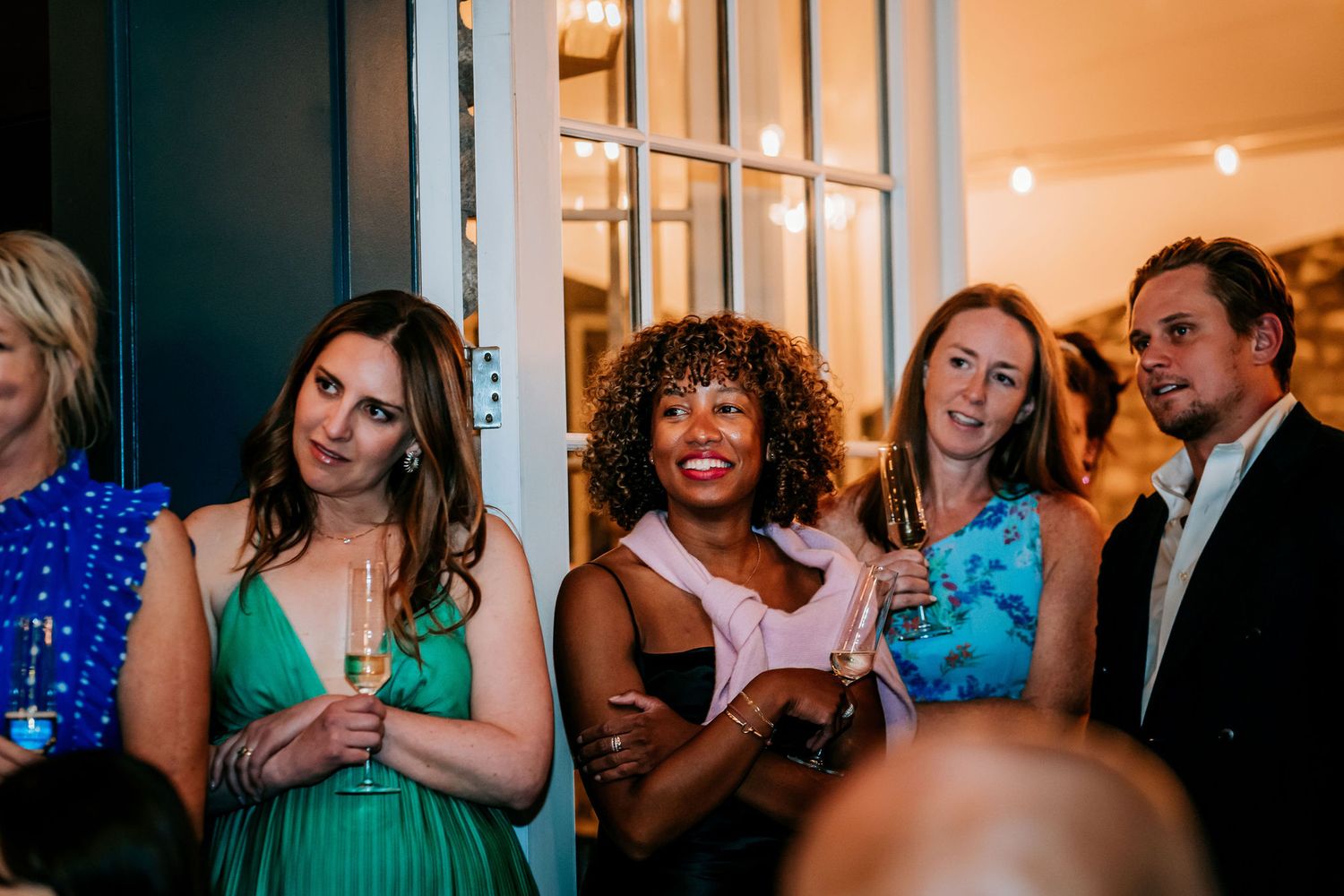 Wedding party guests in colorful dresses enjoying celebration festivities.