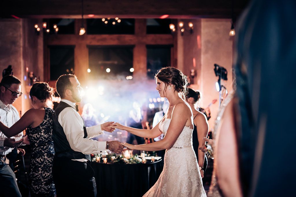 Bride interacting with wedding guests during reception party celebrations.