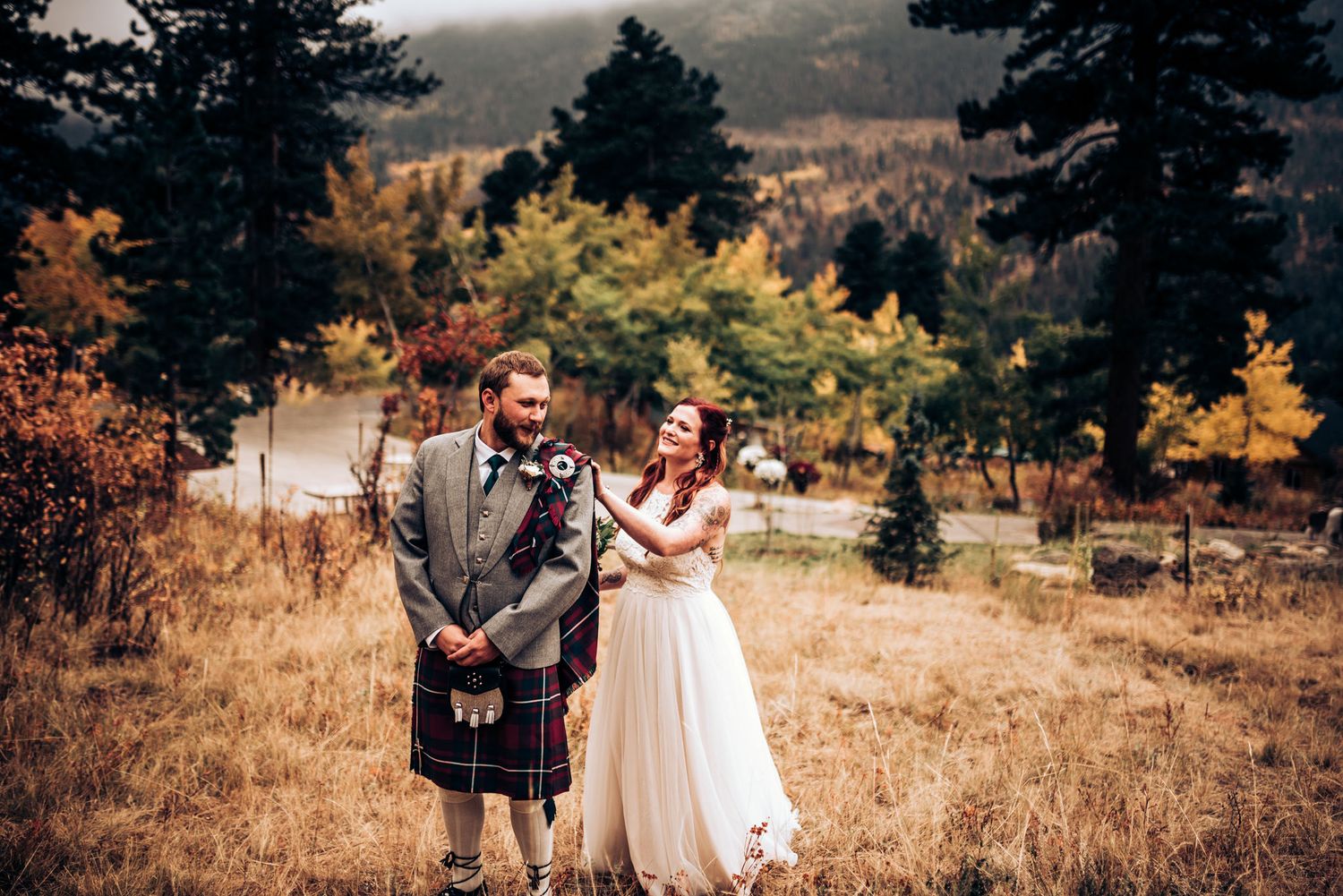 Scottish-themed autumn wedding with couple posing in mountain meadow.