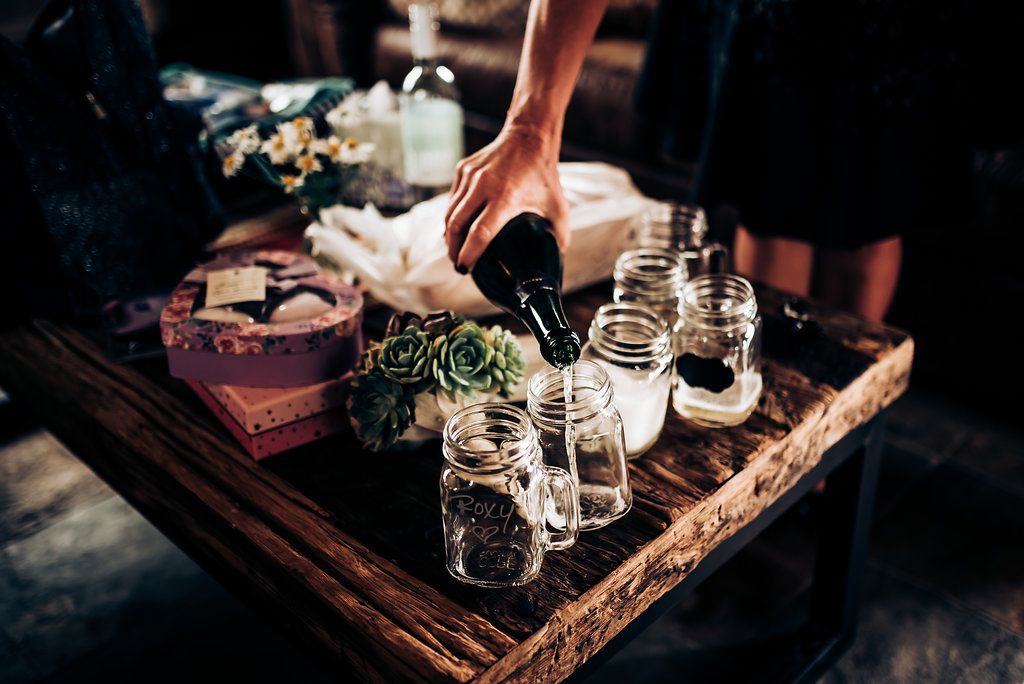 Mason jars and vintage styling details arranged on wooden serving tray.