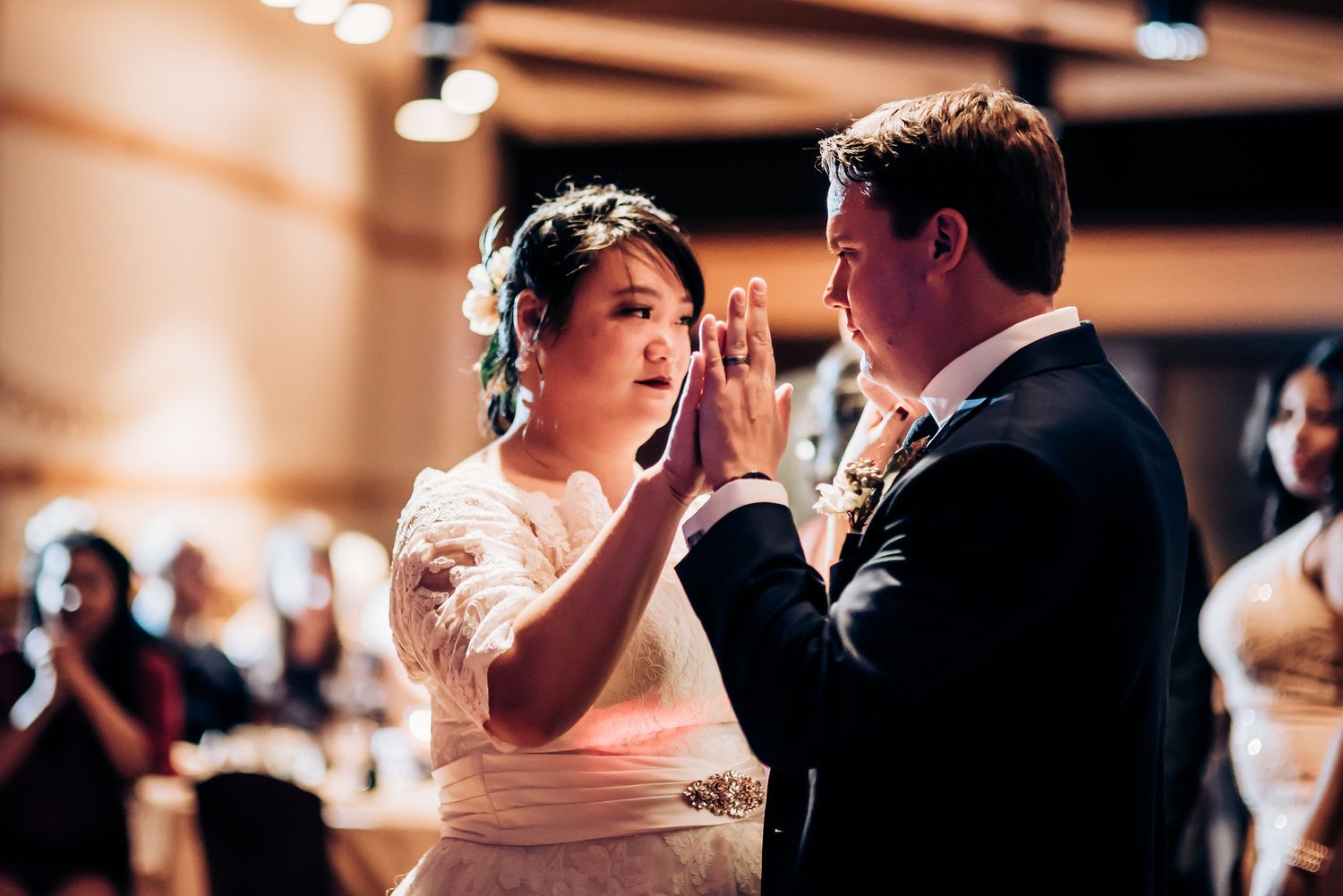 An emotional moment shared between dancing wedding couple at their reception.
