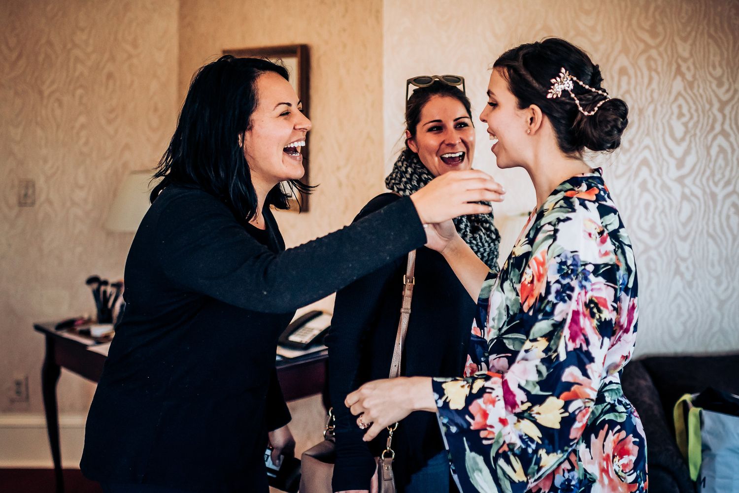 A group shares an energetic moment of laughter and joy in a formal setting.