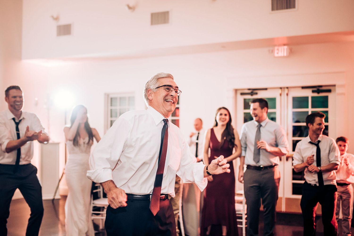 Wedding guests enjoying themselves on the dance floor during a lively celebration.