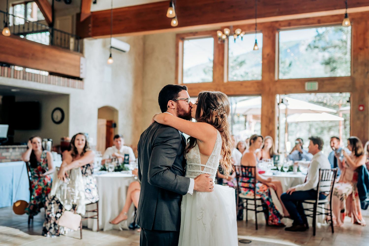 Elegant wedding celebration in a rustic venue with high ceilings and natural light.
