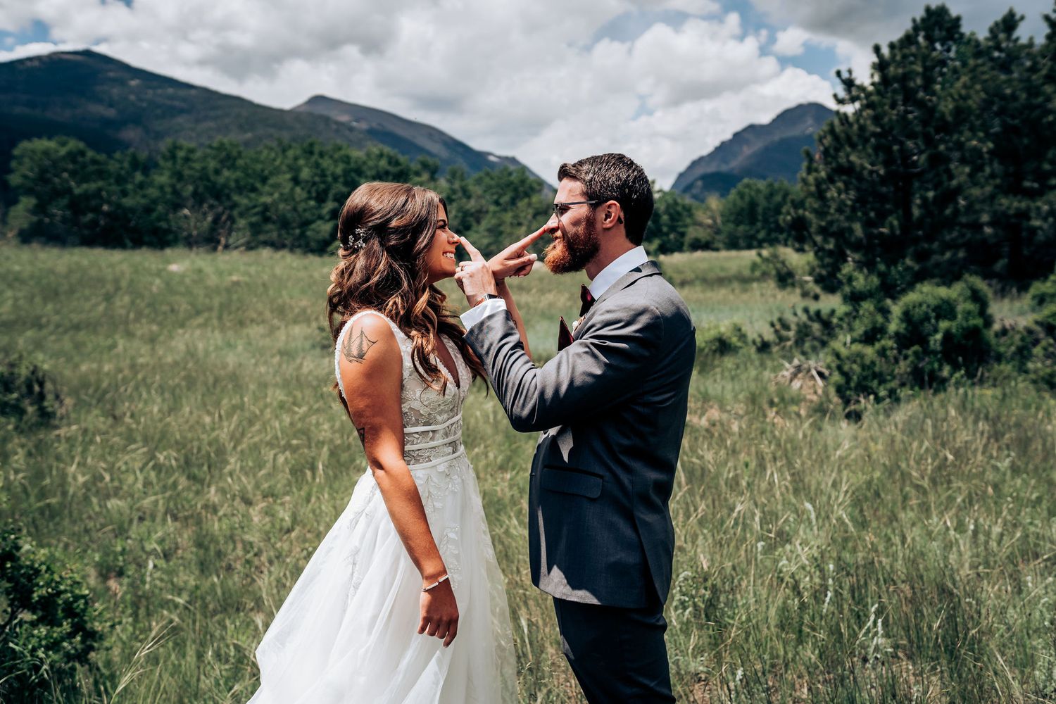 A couple shares a tender moment during their mountain wedding ceremony.