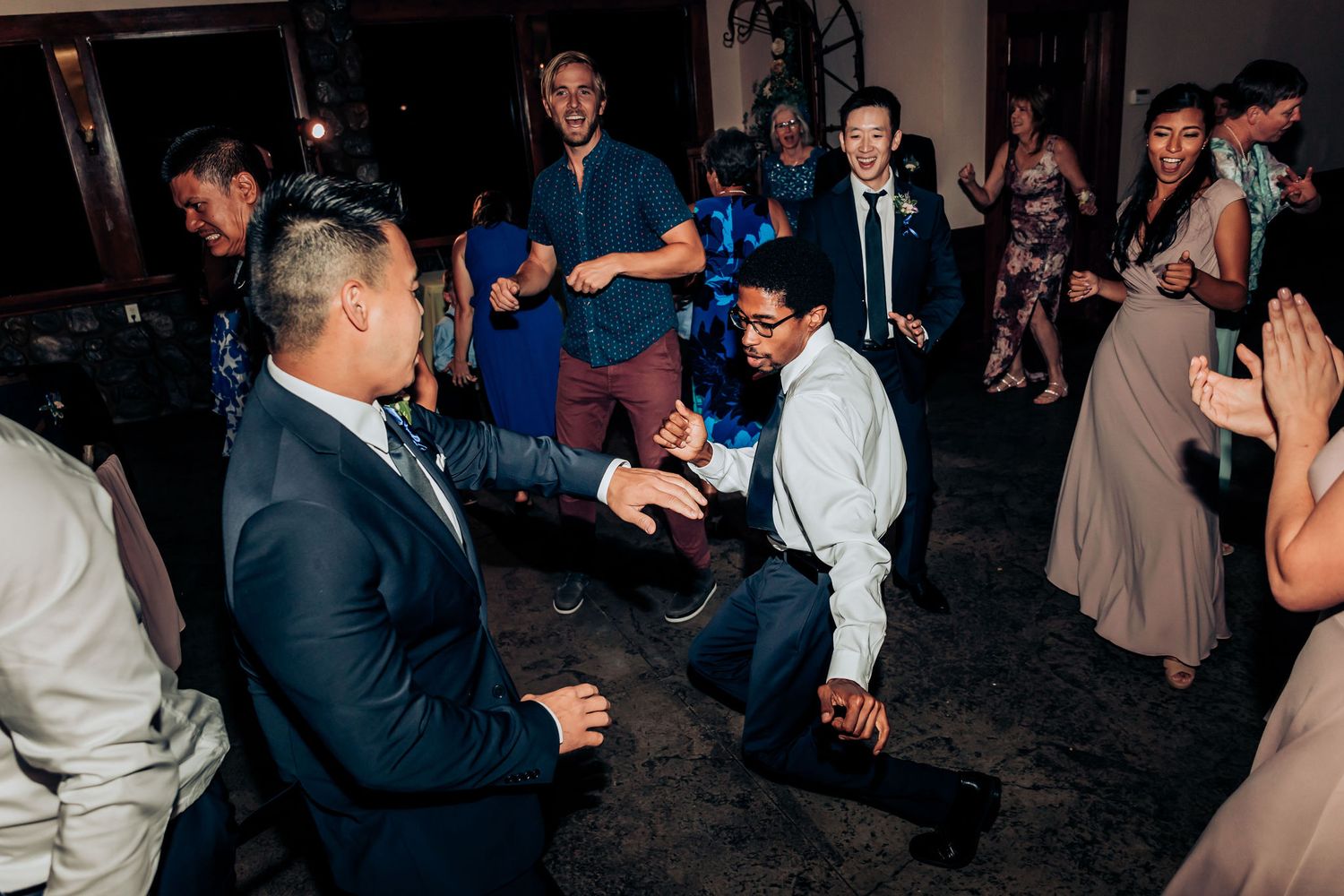 Wedding guests showing off their dance moves during an energetic reception celebration.