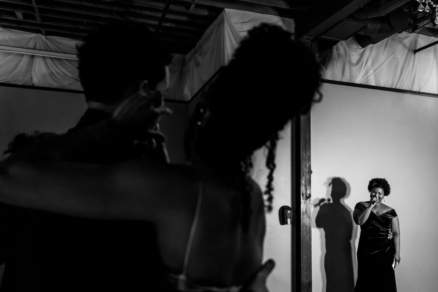 Artistic black and white silhouette of wedding entertainment performers.