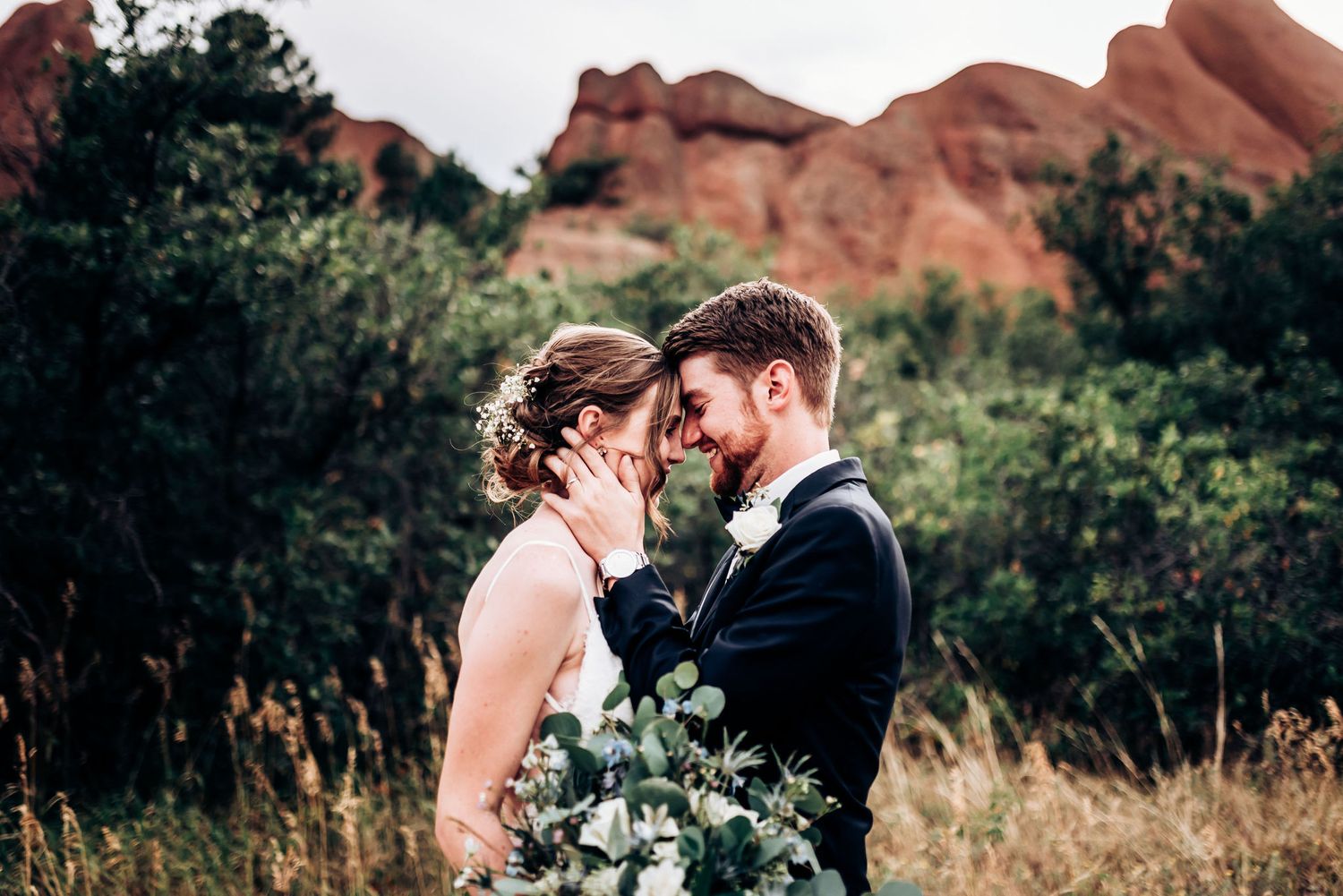 Romantic wedding portrait against stunning red rock formations in nature.