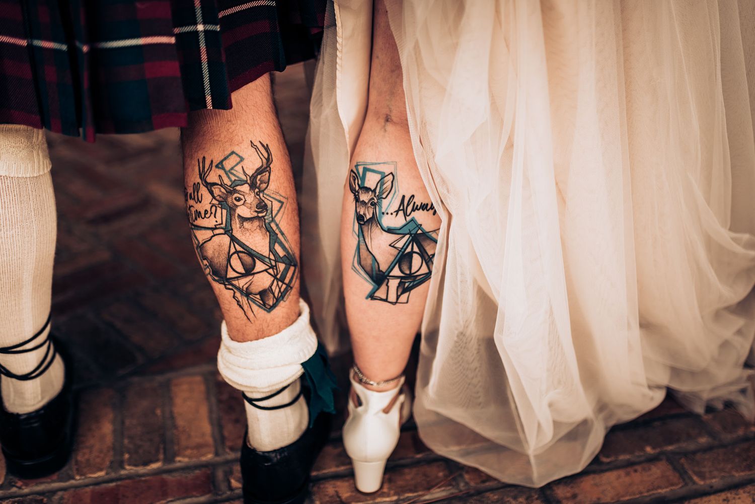 Wedding couple shows matching dog-themed tattoos on their legs.