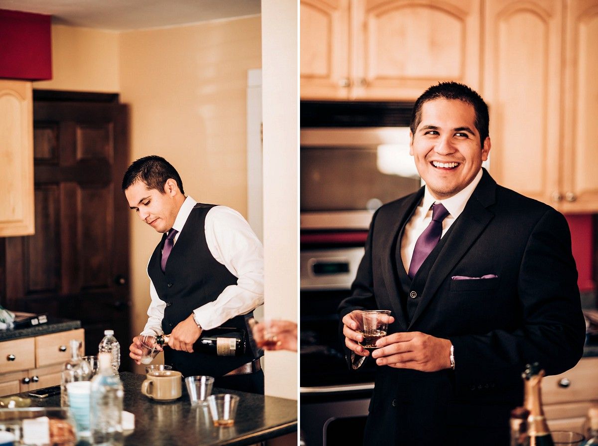 Two people in formal attire prepare drinks in an elegant kitchen setting.