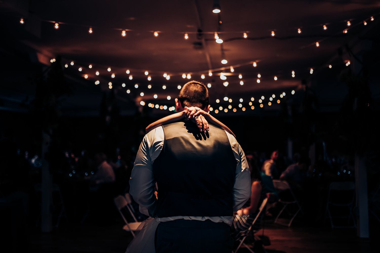 String lights illuminate a dark indoor venue creating a romantic atmosphere.