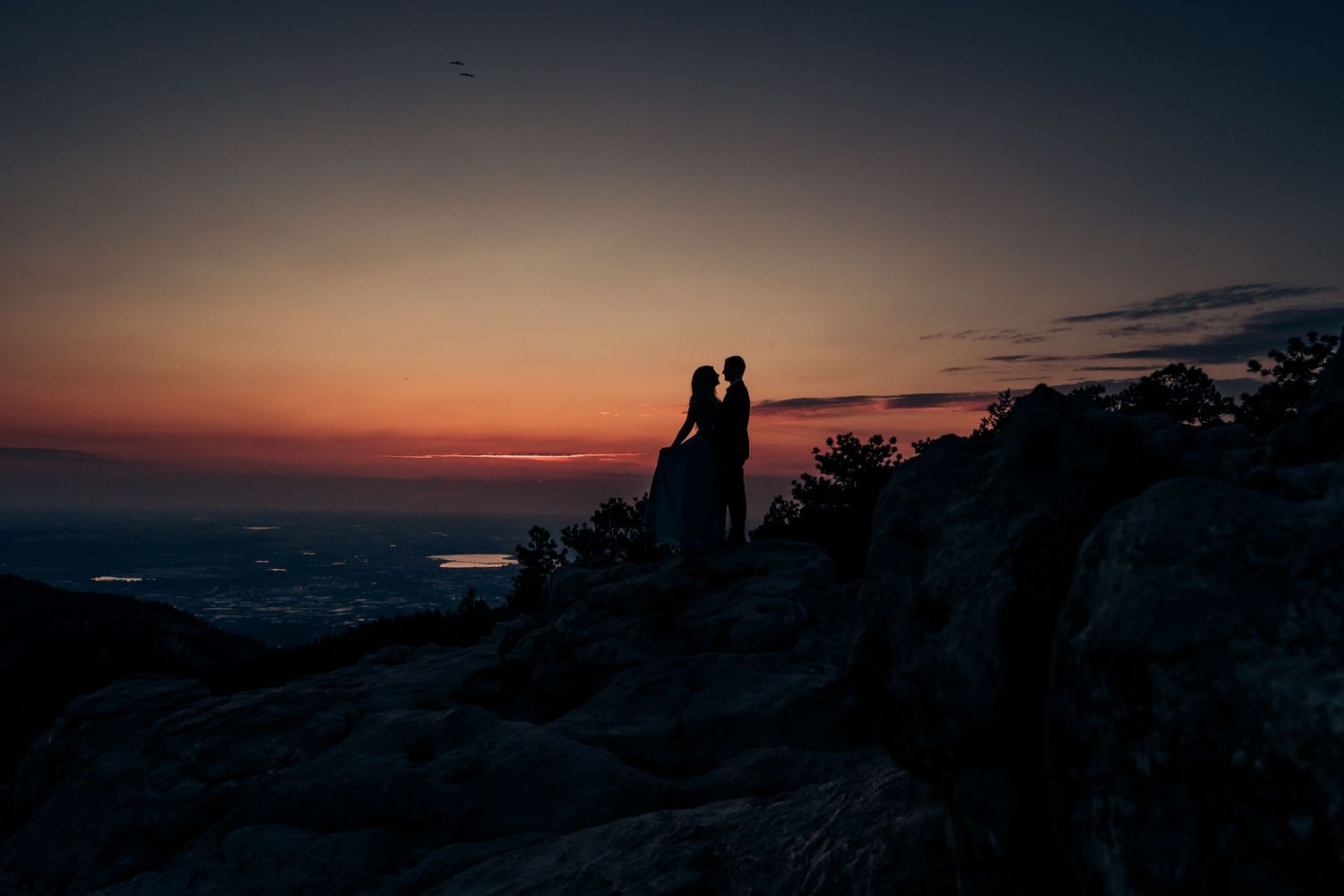 Silhouettes against a dramatic sunset sky.
