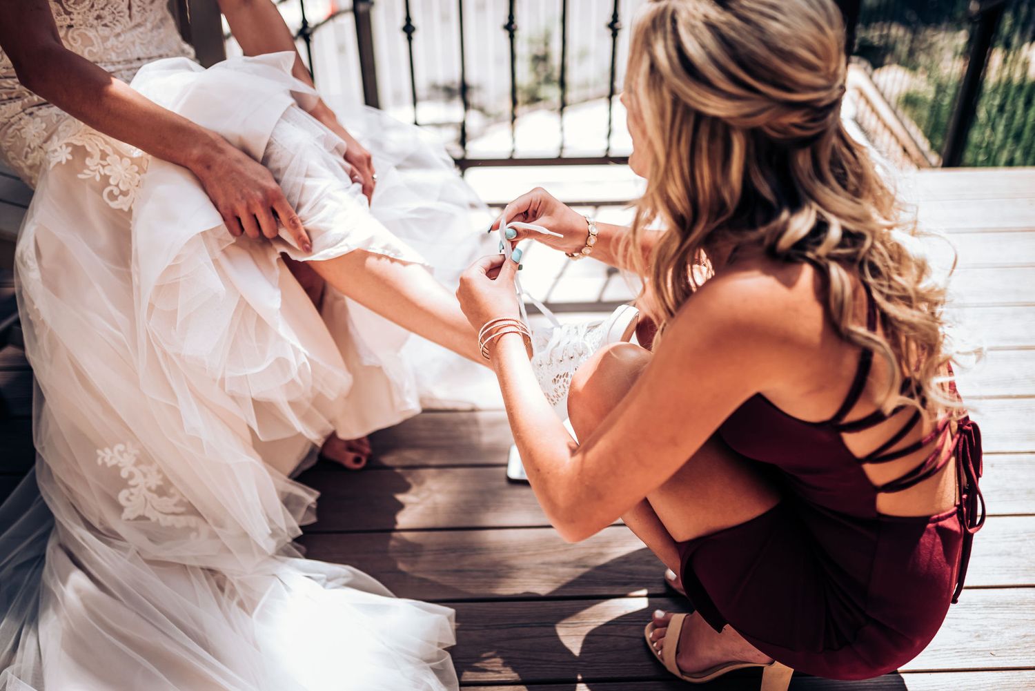 Wedding dress preparation scene showing final touches being made on the bride's dress.