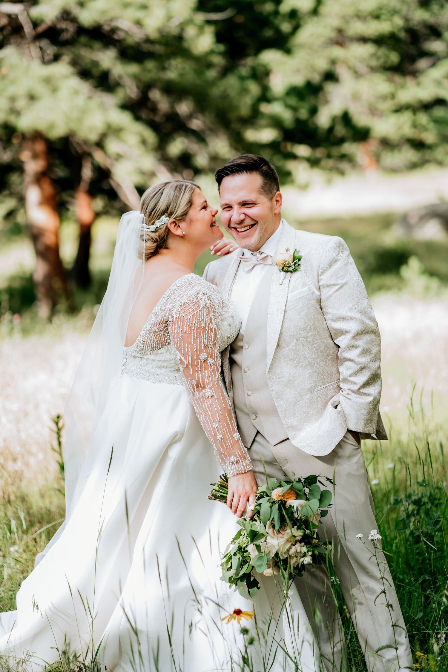 Wedding couple sharing a romantic moment in a sunlit meadow.