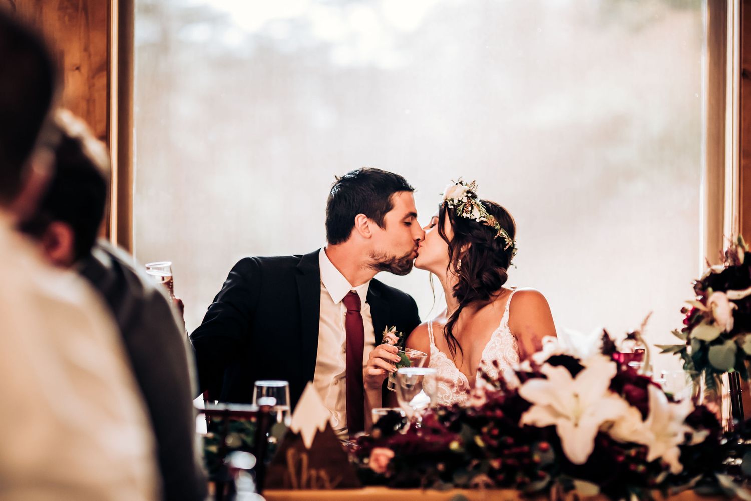 Intimate moment shared during wedding reception with floral decorations.