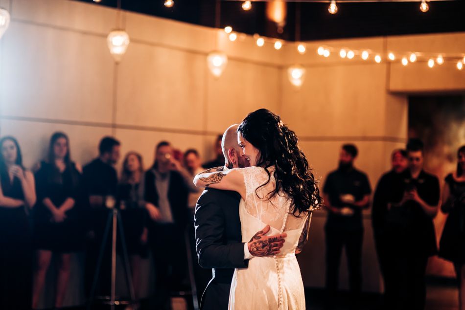 A romantic first dance at a wedding reception with string lights creating a warm ambiance.