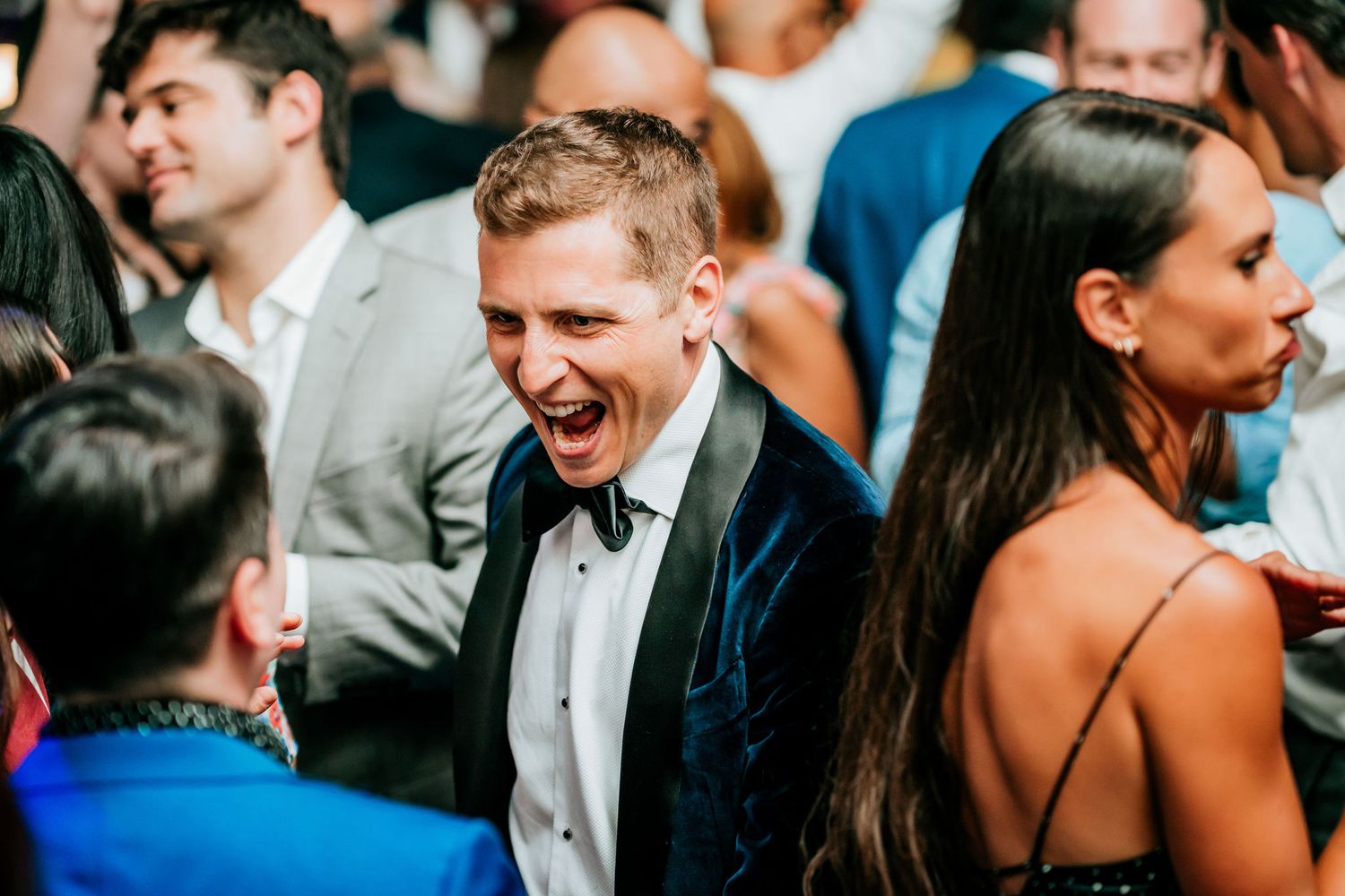 Joyful celebration moment captured during an elegant indoor wedding reception.