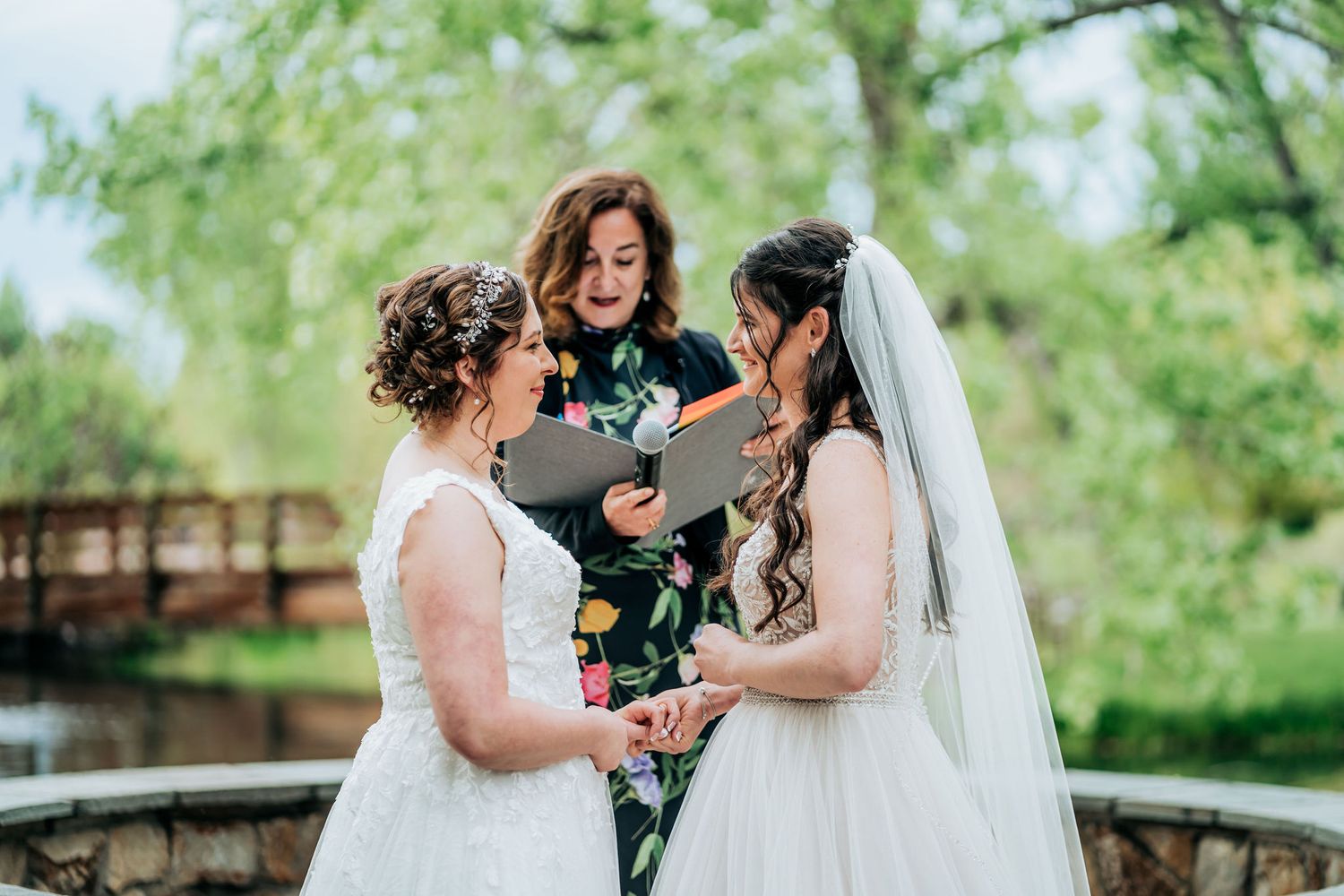 Outdoor wedding ceremony with officiant and couple.