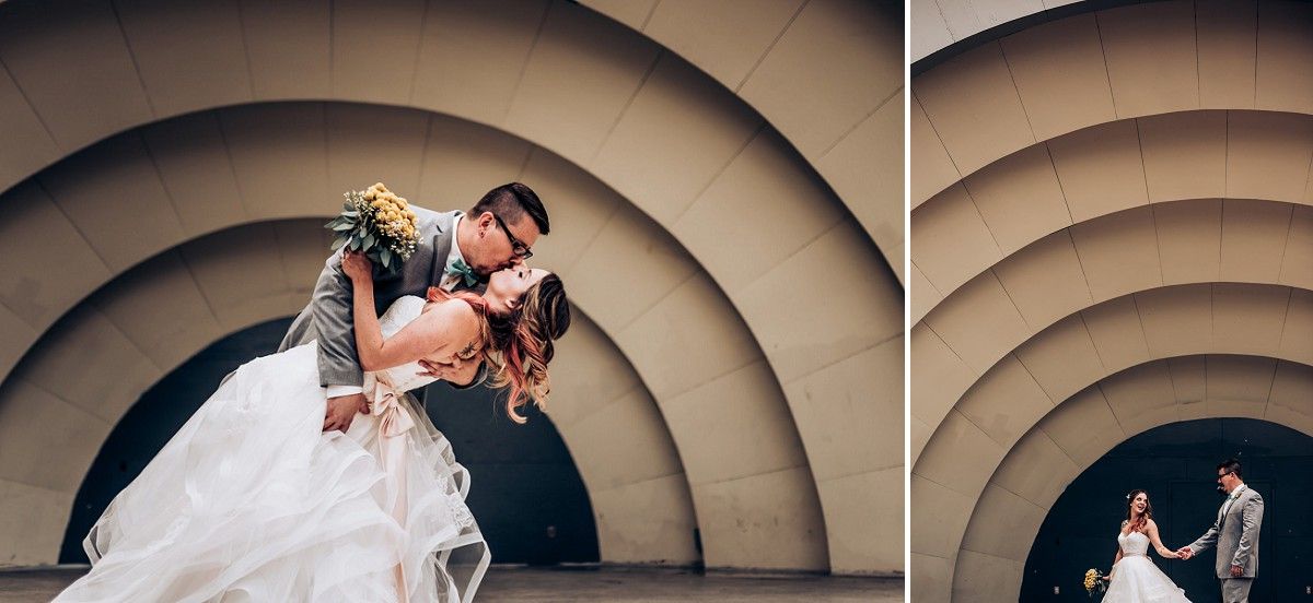 Artistic wedding portrait against circular architectural detail in dramatic lighting.