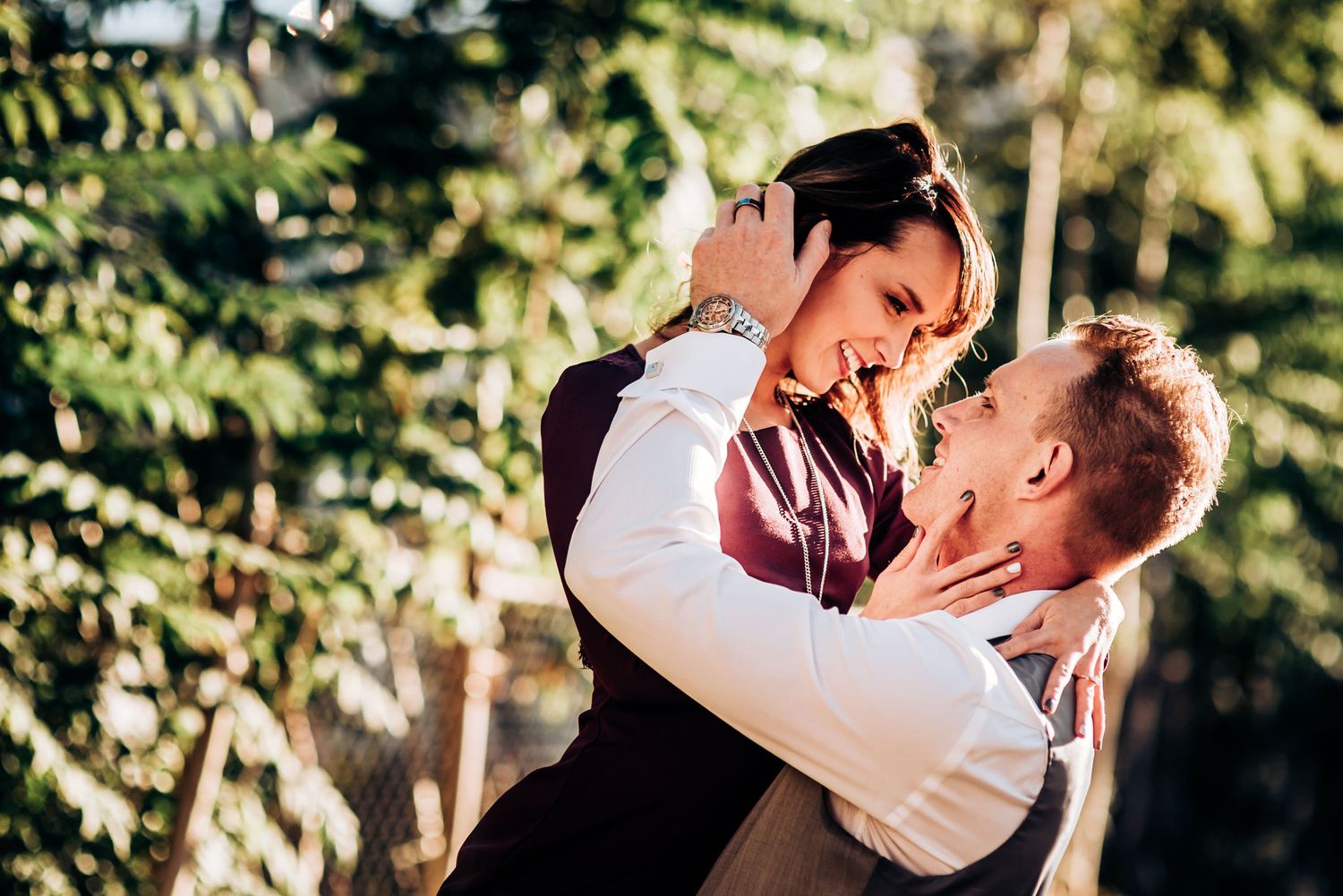 A passionate couple dancing and embracing in a sunlit outdoor setting.
