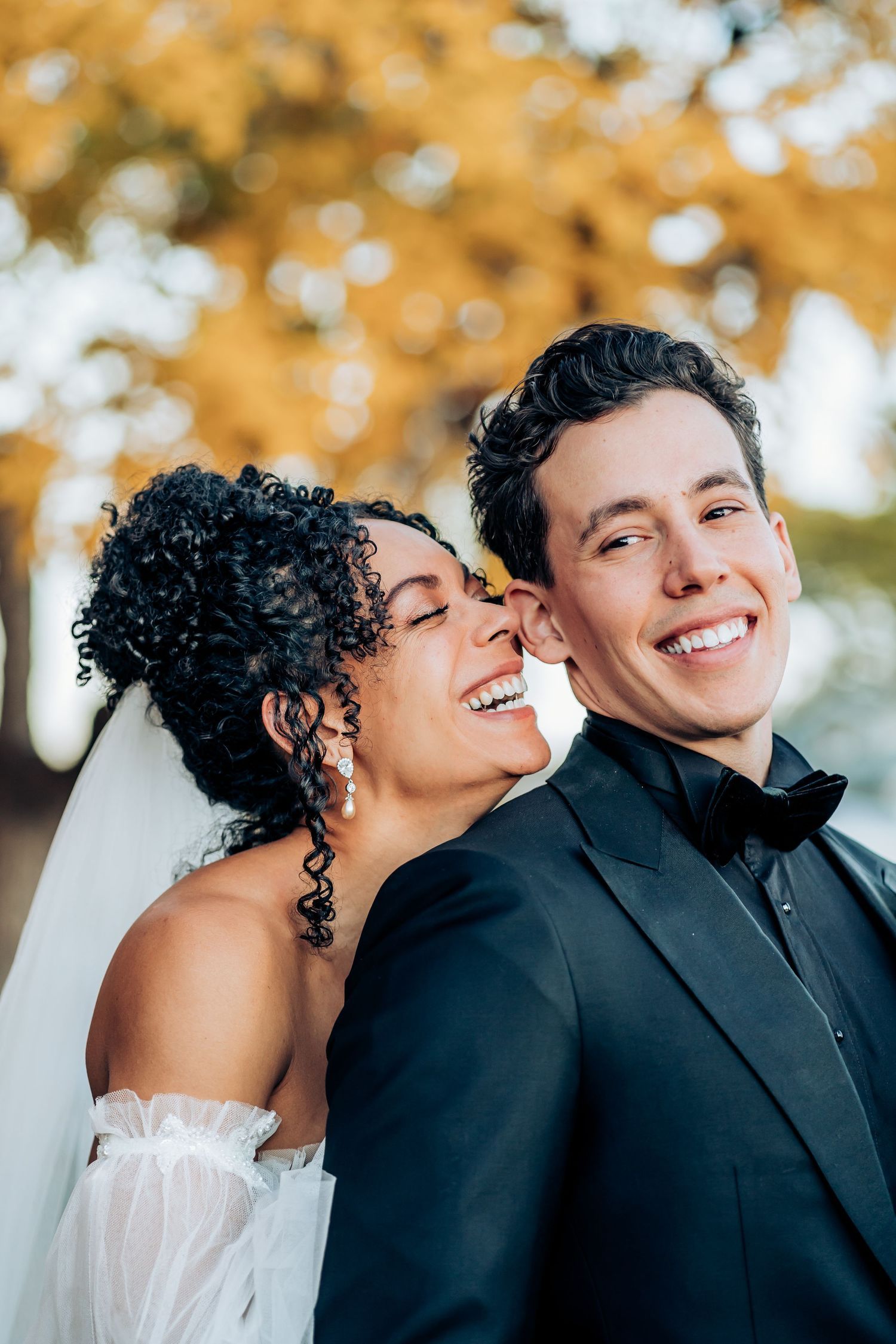 Romantic autumn wedding portraits with golden bokeh background.