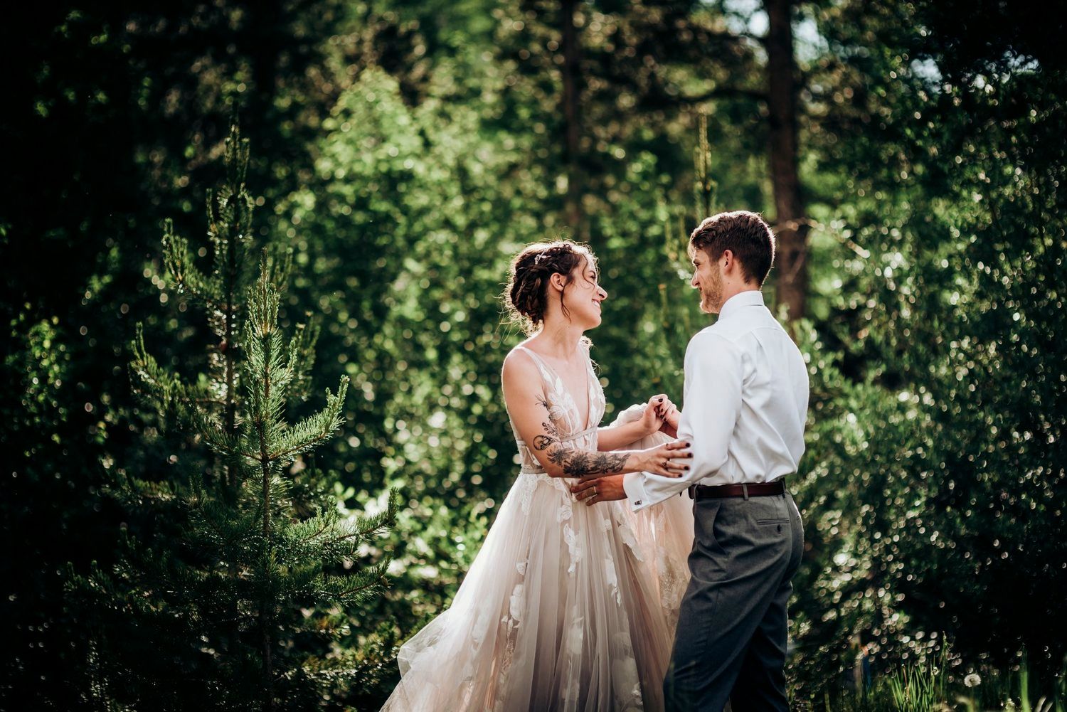 Couple dancing together in a lush green garden setting.