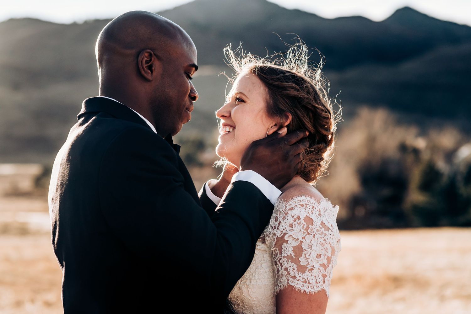 Romantic mountain landscape serves as backdrop for wedding portraits at sunset.