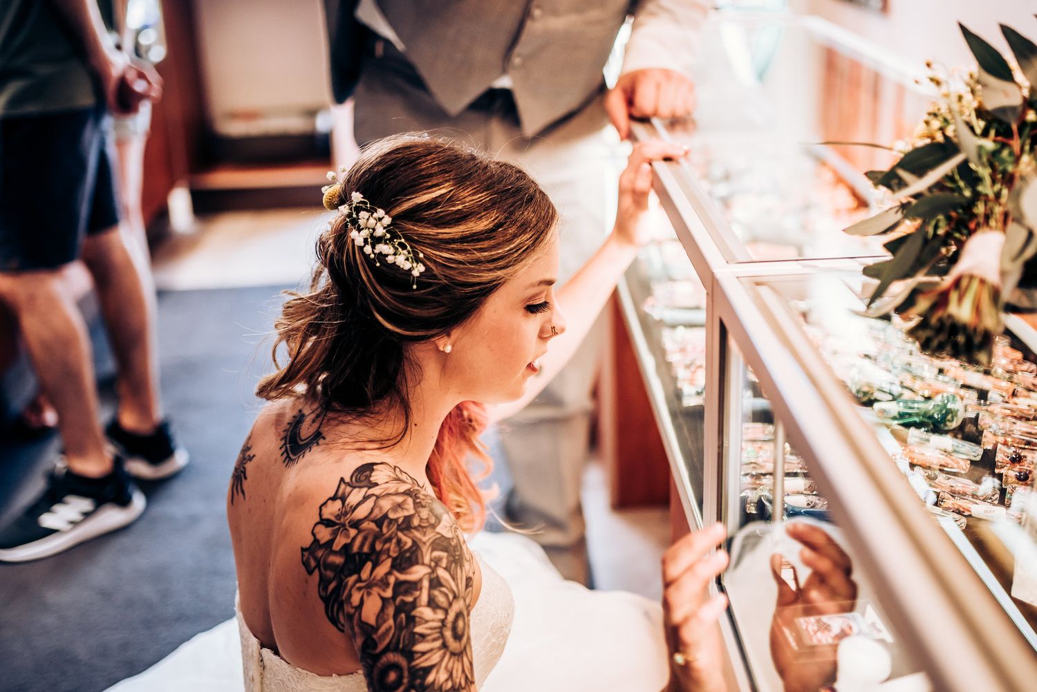 A detailed view of an intricate shoulder tattoo on a bride in her wedding dress.