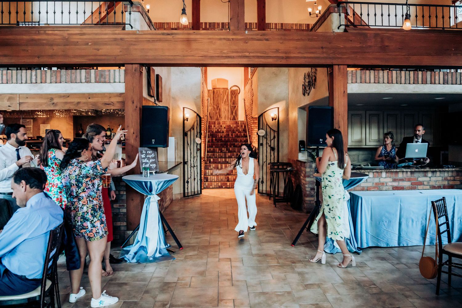 Reception venue interior with wooden beams and elegant party decorations.