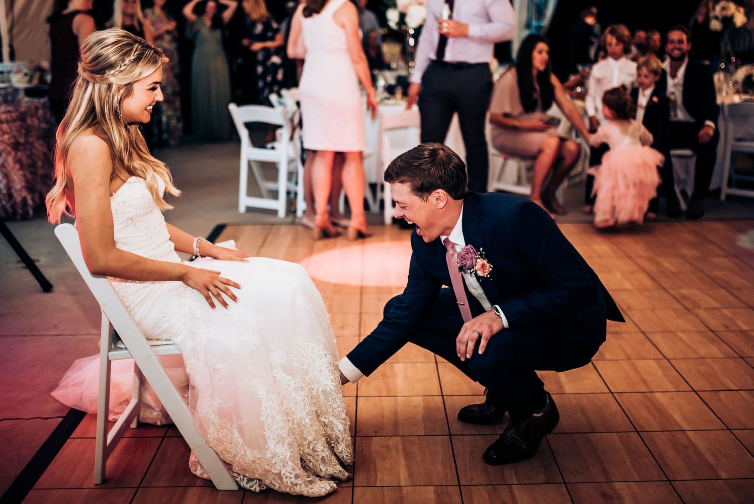 A sweet moment during a wedding reception as couple interacts on the dance floor.