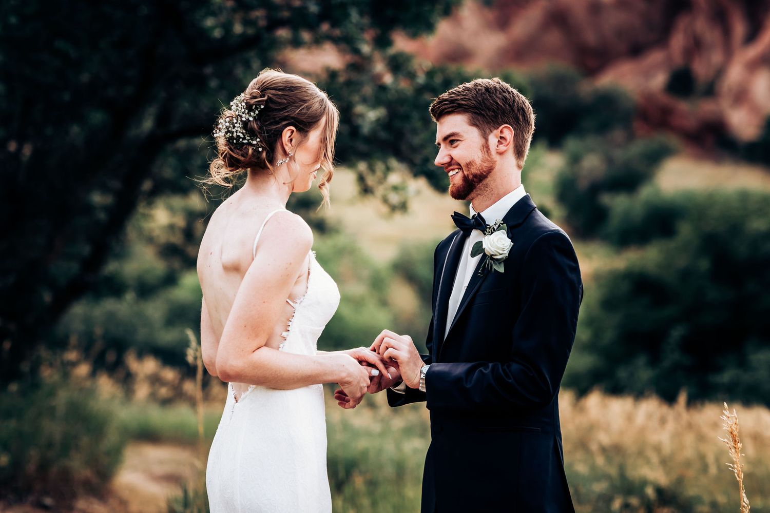 Wedding couple shares intimate moment against backdrop of scenic mountain landscape.
