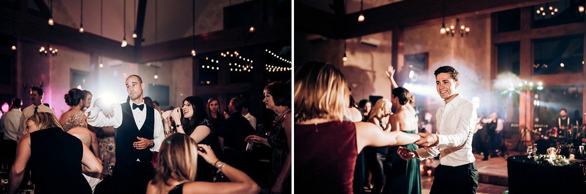 Party guests dancing and celebrating in a venue decorated with ambient string lighting.