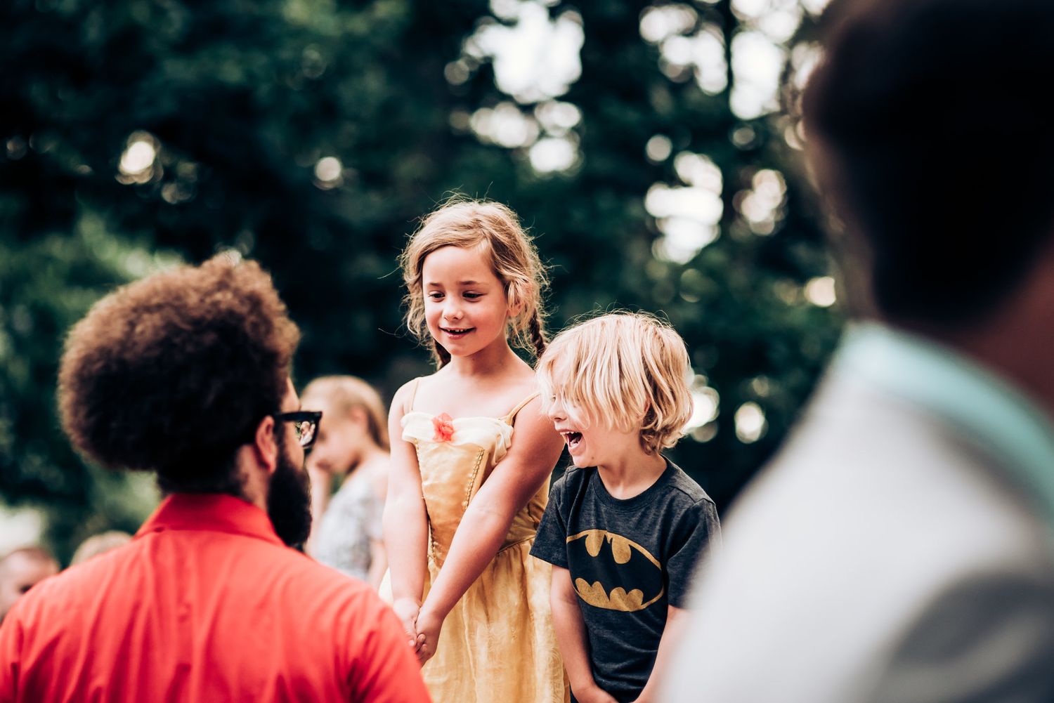 A candid moment captured during wedding festivities outdoors.