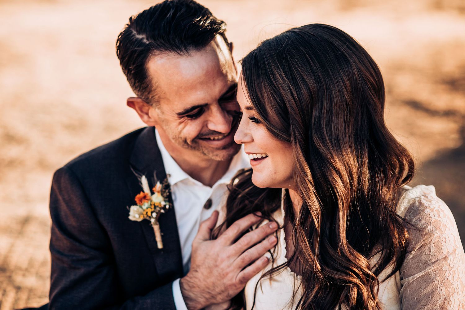 A joyful couple sharing an intimate moment during their outdoor wedding photoshoot.